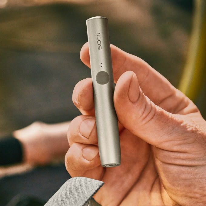 IQOS ILUMA PRIME Your first steps with IQOS ILUMA PRIME Follow this guide to learn all about your new IQOS ILUMA PRIME: How to use, maintain and charge your device to make the most of your experience. Get started with your new IQOS ILUMA PRIME with a few easy steps 1.Before first use, fully charge your device with AC Power Adapter* (sold separately) and Charging Cable for approximately 135 minutes. Tap the button on your IQOS ILUMA PRIME Pocket Charger to check your battery level. If the level is low then charge the pocket charger with a compatible AC power adapter* (sold separately) and cable. 2.By pressing the button at the top of your Pocket Charger for four seconds you can turn the device ON/OFF. Then check the status lights on your IQOS ILUMA PRIME Holder to see how many experiences you have. Two lights mean it’s fully charged (ready for two uses). One light means it’s ready for one use. No lights mean the Holder needs to be charged in the Pocket Charger. 3.Gently insert a SMARTCORE stick as seen in the video. The Autostart is activated upon insertion of the SMARTCORE stick. If the Autostart is disabled, you can press the button on the Holder to start the experience. One vibration and lights pulsing slowly means it’s heating up the SMARTCORE stick. Two vibrations and light(s) ON means it is ready for use. 4.When you feel another two vibrations, your IQOS time is nearly up (30 sec or 2 puffs remaining). Simply remove the SMARTCORE stick and remember to use a new stick for your next experience. Remember that one light means you only have one experience left, so you'll need to charge the Holder in the Pocket Charger after your next experience. 5.When your Holder is in the Pocket Charger there are two round lights that indicate the status of the Holder. When the round lights are pulsing white, this means the Holder is getting charged. One or two solid round lights on the Pocket Charger indicates how many experiences you have readily available. *Disclaimer: The AC Power Adapter is not included. Do use the IQOS Power Adapter from your previous IQOS device or purchase it separately at iqos.com or IQOS stores. See FAQ for more information. Get ready to experience next level tobacco with IQOS ILUMA PRIME, our most refined and advanced device yet. With SMARTCORE INDUCTION SYSTEM™ technology at its core, it delivers a clean and effortless experience. Because it heats from the inside out - IQOS ILUMA PRIME makes the perfect choice.